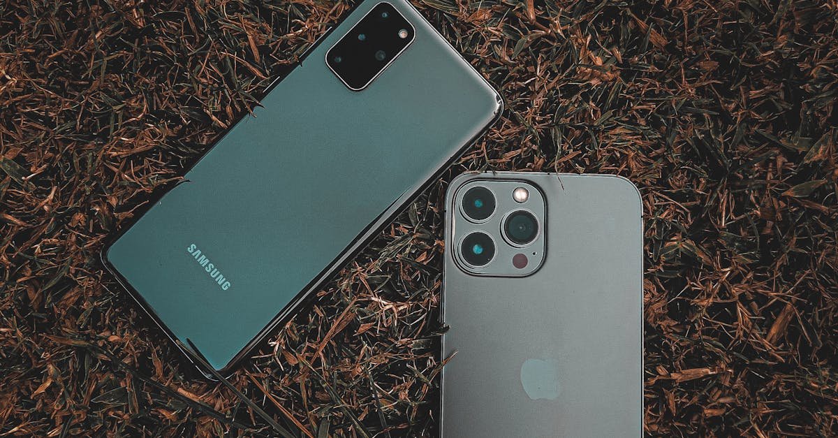 Top view of Samsung and iPhone placed on a grassy surface, showcasing modern smartphone design.
